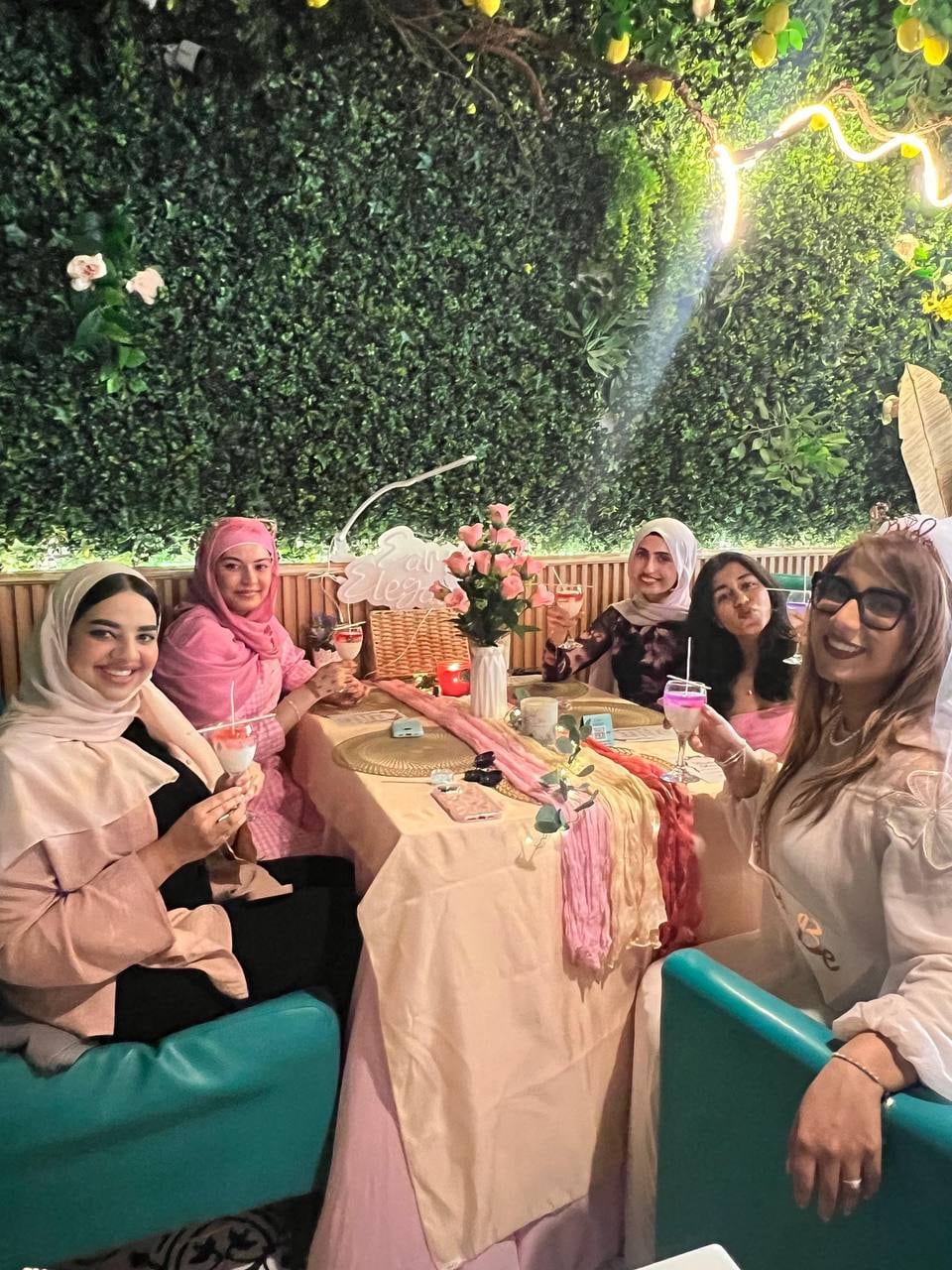 Guests celebrating at an Earthy Elegance bridal shower, with Earthy Elegance signage in the background